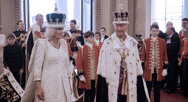 <p>King Charles III and Queen Camilla in coronation gowns and crowns at Buckingham Palace on the big day</p>